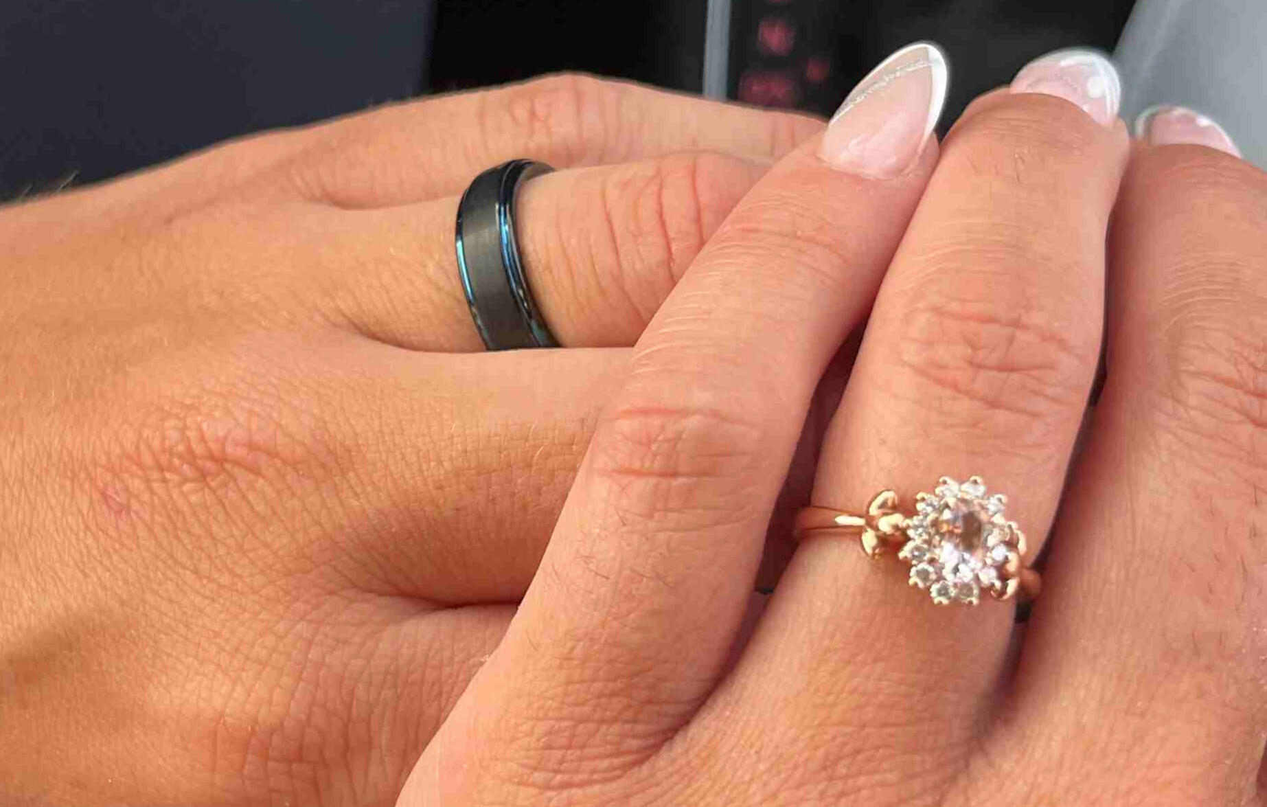 Marriage photo shoot with couple holding hands and wedding rings shown for both people in Milos Greece, photo taken by Mia's Photography and Events.